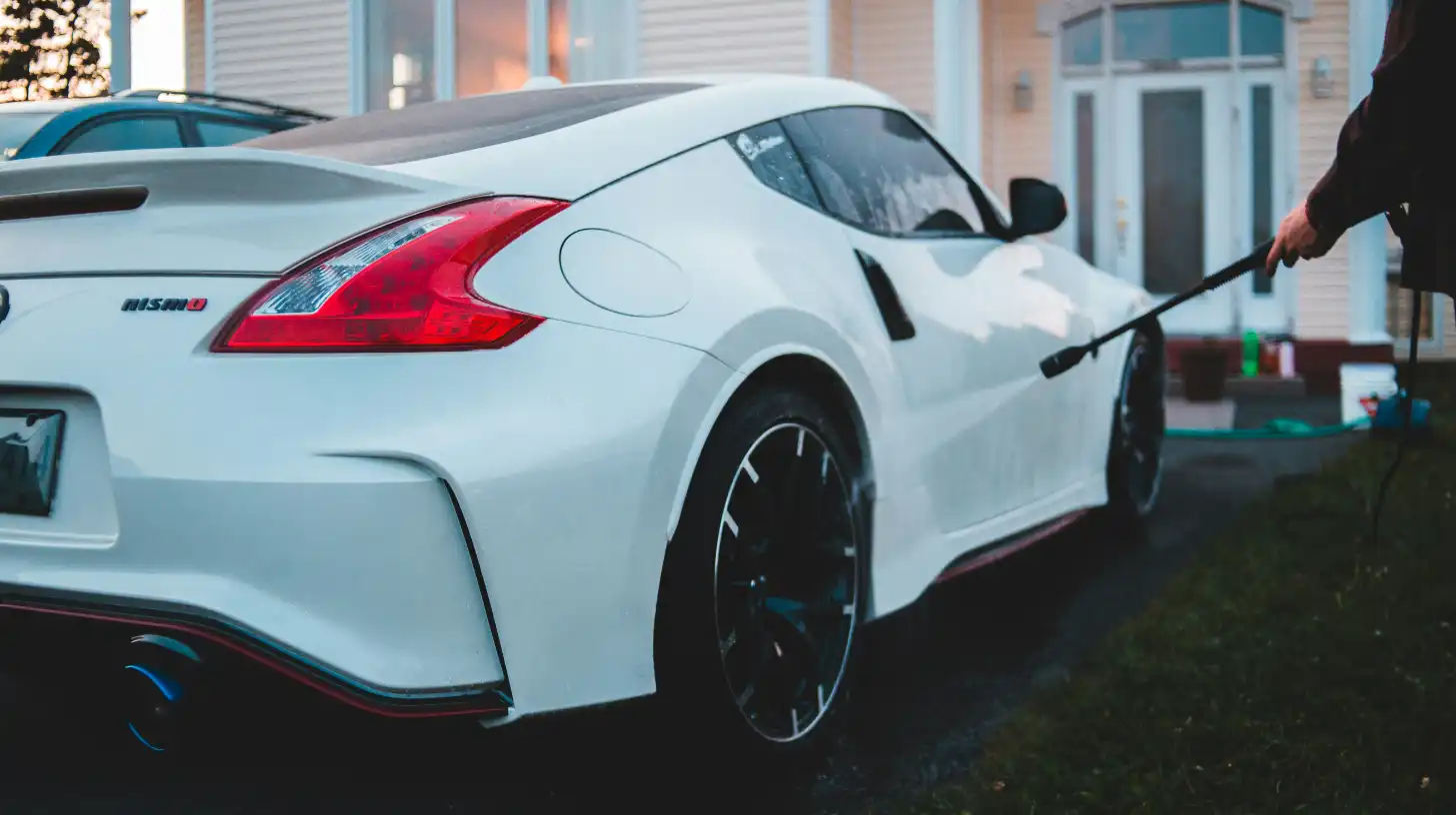 Person mobile detailing a Nissan